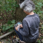 A snapshot volunteer setting up her trail camera