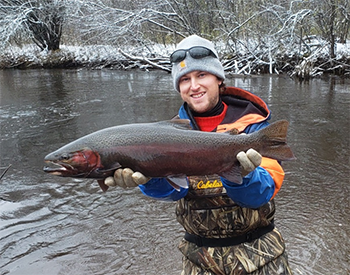 Fisheries Biologist Nathan Thomas with a steelhead from the Brule River.