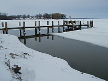 Ice near pier on lake